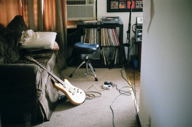 Music room couch with a guitar and a vinyl