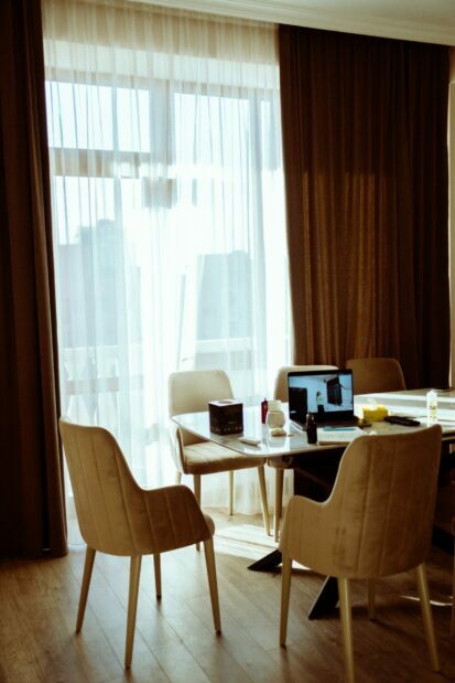 Laptop in a table in a room with large curtains