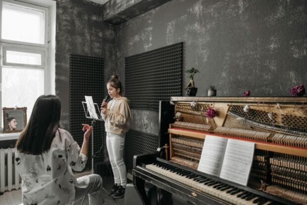 Two women recording in a soundproof music room