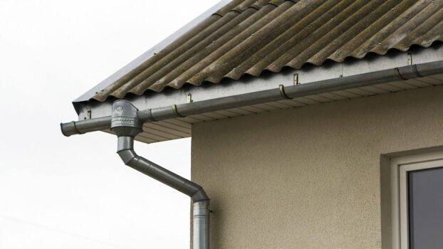 Corner of a house with a steel gutter system. My two favourite methods for managing runoff