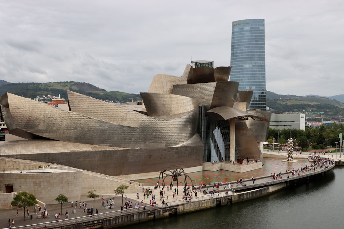 Frank Gehry: Biography, Works, Awards 32 Aerial view of the crowded promenade in front of the guggenheim museum bilbao - © johan van geijl