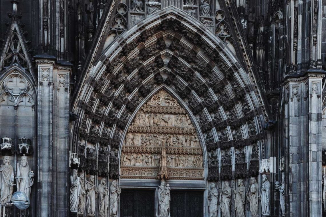 Architectural landmark: cologne cathedral entrance carvings © masood aslami