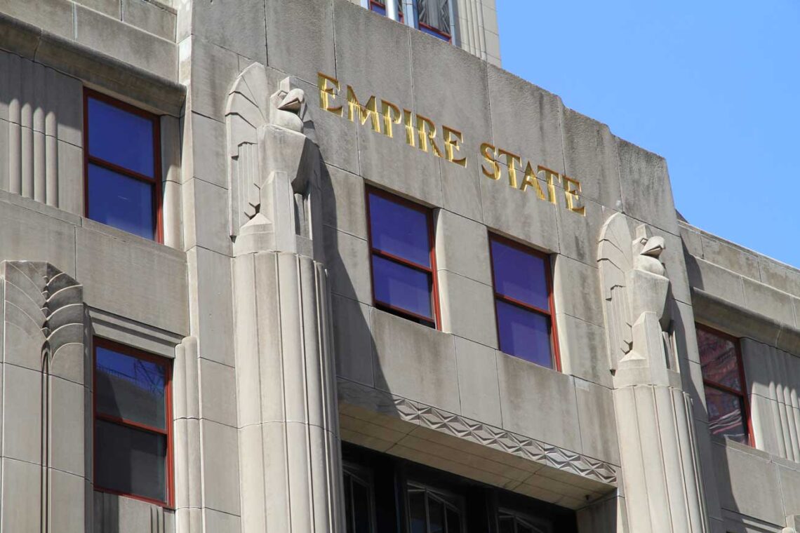 Architectural landmark: empire state building sculpted concrete eagles above the fifth avenue entrance © ingfbruno