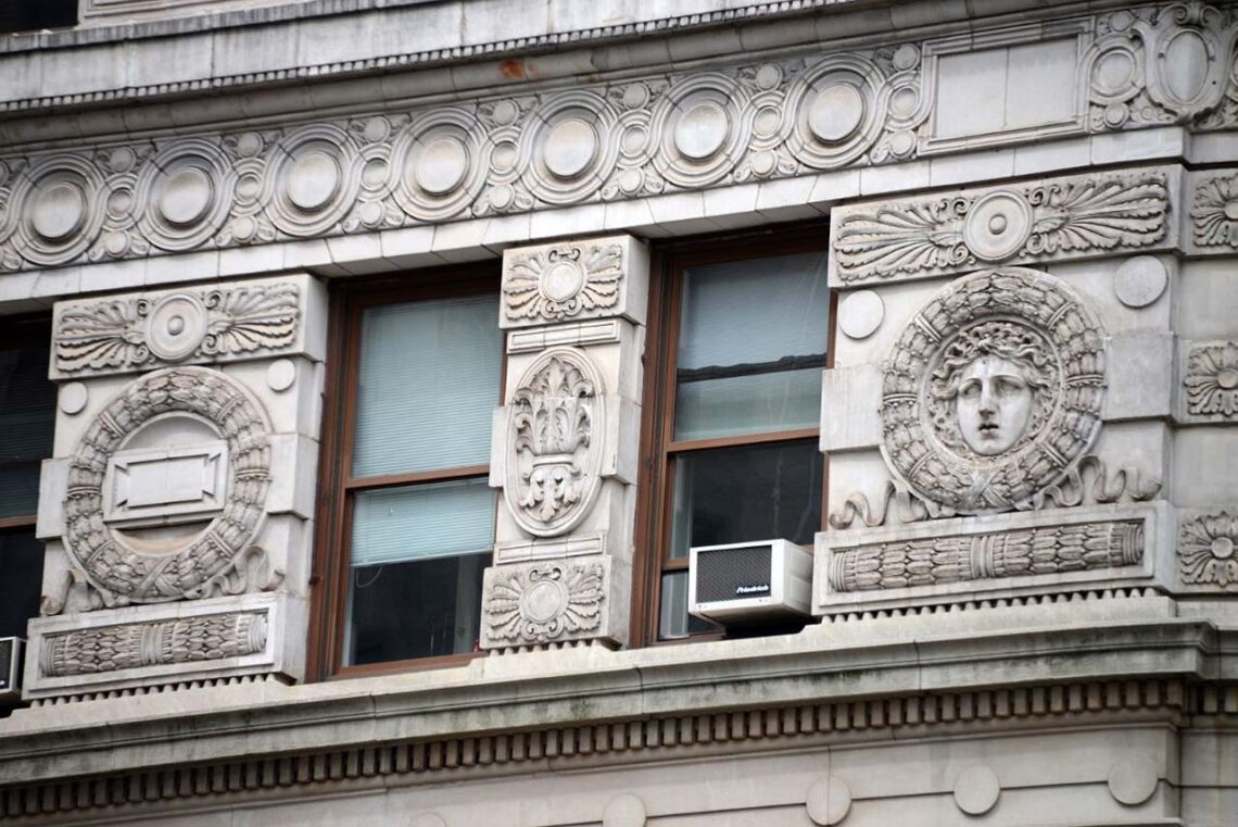 Architectural landmark: flatiron building closeup of the carvings © mountains of travel