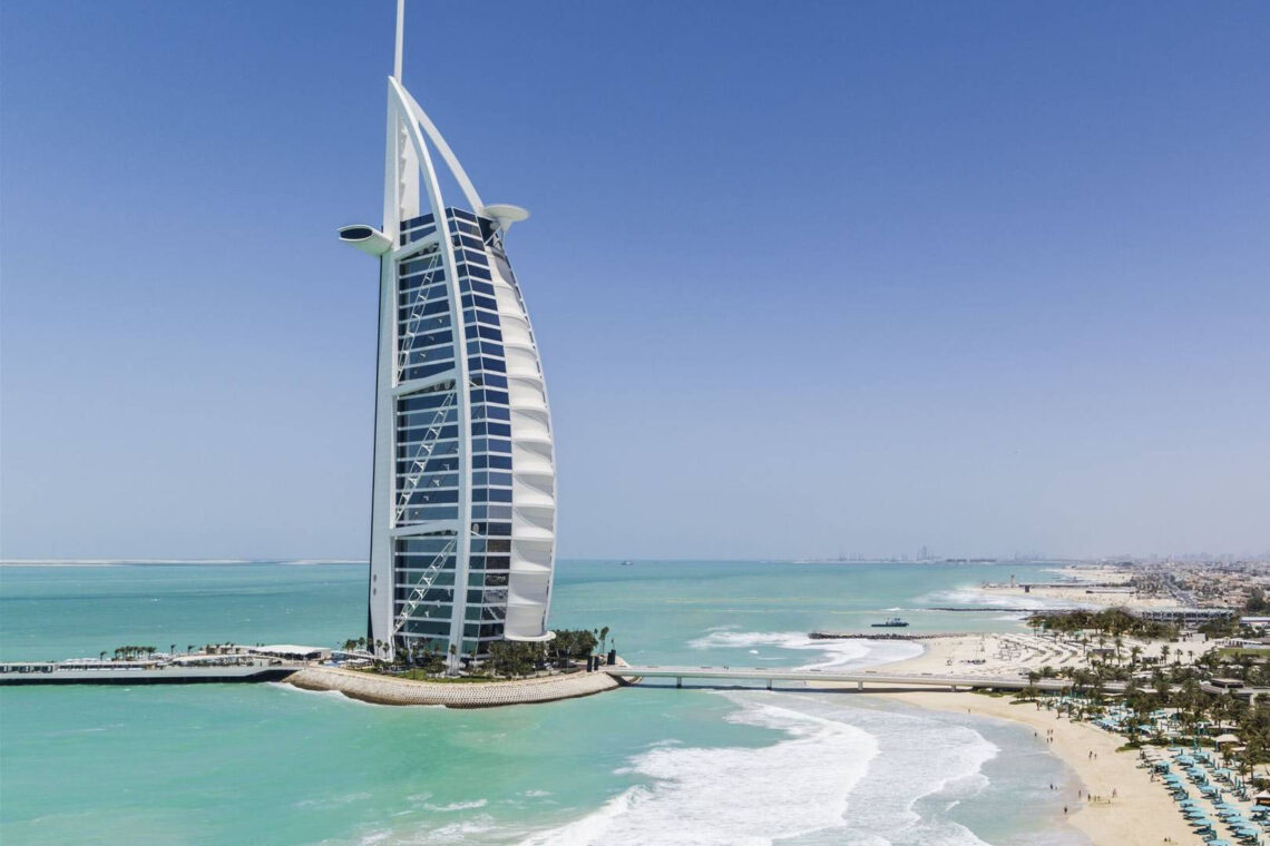 Atkins: burj al arab hotel, dubai - innovative sail-shaped luxury hotel with an exoskeleton steel structure, designed to withstand high winds and seismic activity, completed in 1999.