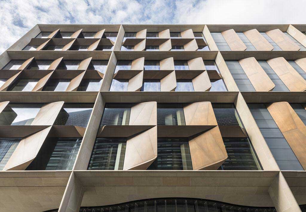 Sweco: bloomberg european headquarters exterior closeup made from sandstone, bronze, and american red oak