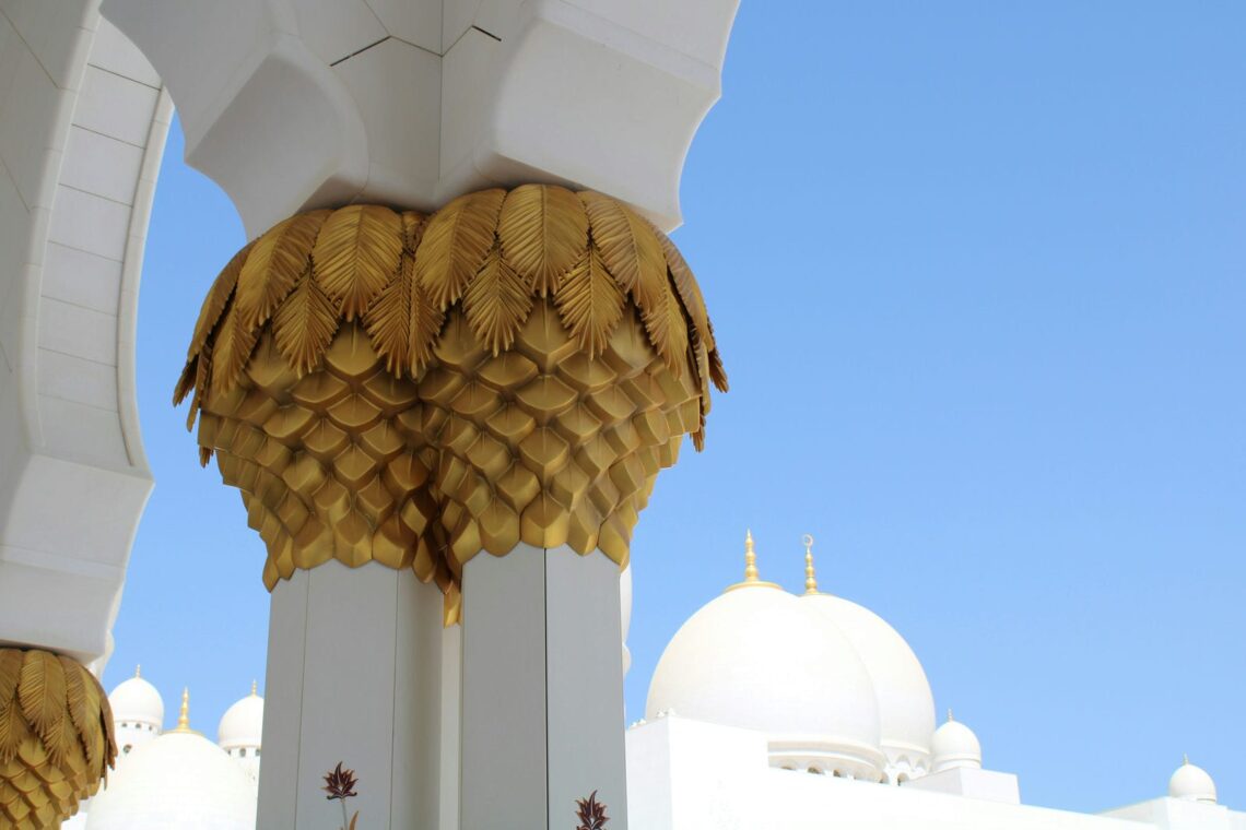 Architectural landmark: sheikh zayed grand mosque golden palm tree carved on pillars © live2makan