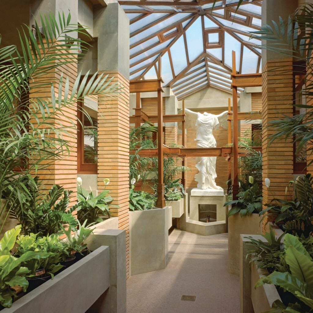 Interior view of the reconstructed conservatory, featuring a replica of the nike of samothrace statue to complete the setting. © biff henrich